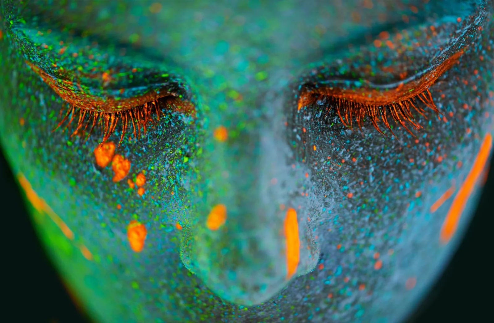 A close-up of a face covered in colourful pigment